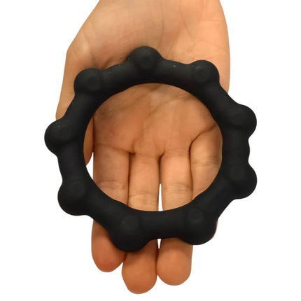 Octopop - Quiet. Wearable. Satisfying black sensory fidget ring held in hand, designed for calming tactile stimulation