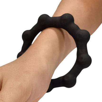 Black textured wearable sensory ring fidget on wrist demonstrating Octopop - Quiet. Wearable. Satisfying.