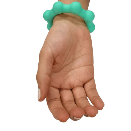 Hand wearing a teal sensory fidget bracelet designed for calming called Octopop - Quiet. Wearable. Satisfying