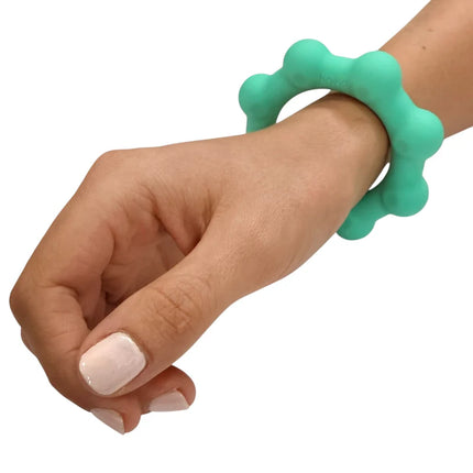 Octopop - Quiet. Wearable. Satisfying sensory fidget bracelet in teal worn on wrist, promoting focus and calm.
