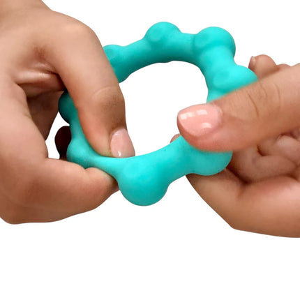 Hands squeezing a blue sensory fidget toy called Octopop - Quiet. Wearable. Satisfying in use.