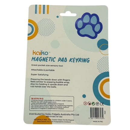 Packaging for Paw Magnetic Pad Keyring featuring a blue paw print design, describing it as a portable sensory tool with magnetic beads for tactile stimulation.
