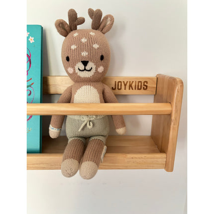JORY W1 — Front-Facing Wall Bookshelf holding a soft reindeer toy with a children's book nearby. Helping families thrive with tools to calm, connect and support.