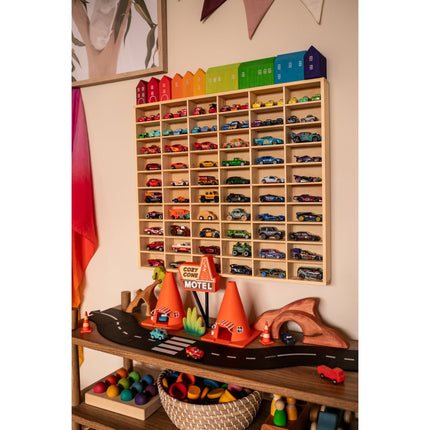 JCAR 60 —Diecast Display Rack filled with colorful toy cars above a kids' play road scene, helping families thrive.