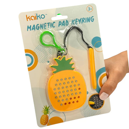 Pineapple Magnetic Pad Keyring with yellow and green pineapple design, attached stylus, displayed in retail packaging held by a hand.