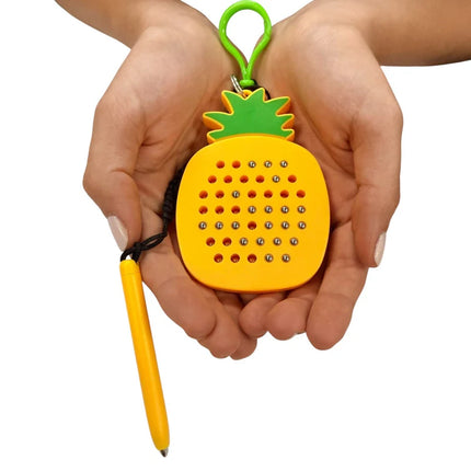 Hands holding a Pineapple Magnetic Pad Keyring, featuring a yellow pineapple shape with green leaves and small magnetic beads arranged in a grid, attached to a yellow stylus.
