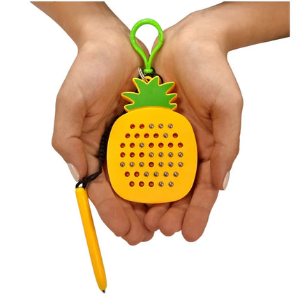 Hands holding a Pineapple Magnetic Pad Keyring shaped like a pineapple with colorful magnetic beads and attached stylus for sensory play and fine motor skills.