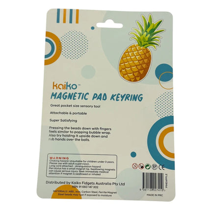 Pineapple Magnetic Pad Keyring packaging showing colorful geometric design and product information about the sensory toy’s features and safety warnings.
