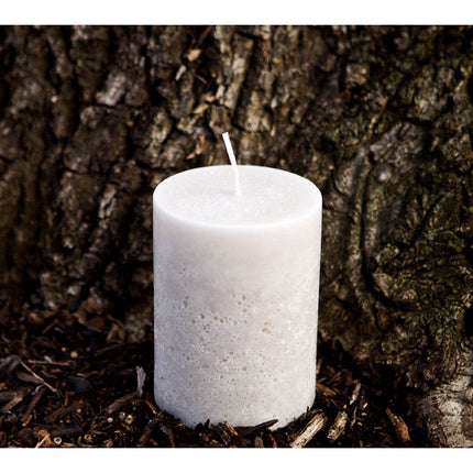 Off White Pillar Candle Rustic Relic Design with stone texture on natural wood mulch background