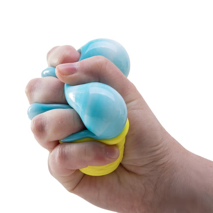 Hand squeezing a blue and yellow sensory fidget toy on a white background