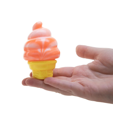 Hand holding an orange and yellow ice cream-shaped object