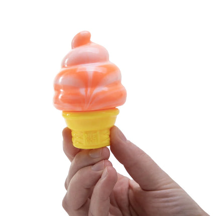 Hand holding an orange ice cream cone shaped squishy