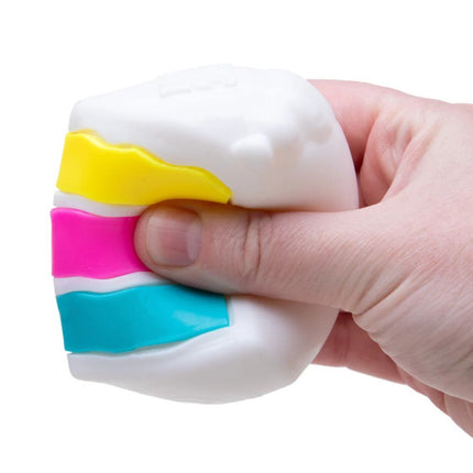 Schylling - Peace O Cake NeeDoh sensory squishy toy being squeezed by hand
