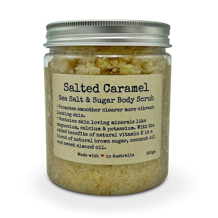 Salted Caramel Body Scrub with Vitamin E in a clear jar with a metal lid for skin renewal and calming support.