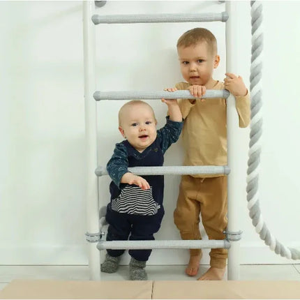Two young children using the Sensory Swedish Wall Bars - Adjustable, helping families thrive with tools to calm connect and support
