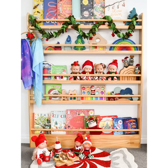 JORY 5 — Front-Facing Bookshelf holding colorful books, toys, and decorative plush dolls with garland accents.