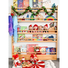 JORY 5 — Front-Facing Bookshelf holding colorful books, toys, and decorative plush dolls with garland accents.