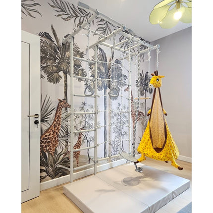 Swedish Giant Wallbars - S7 with ropes, rings, swing, and soft mat in a playful room with giraffe wall art
