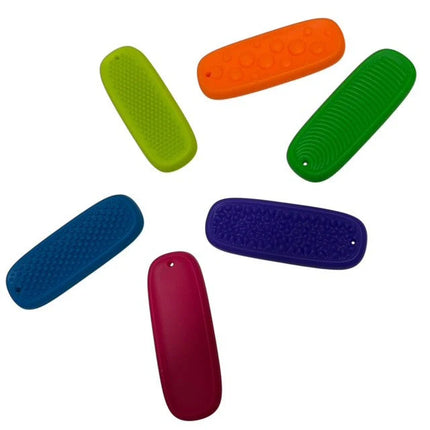 Tac Tiles in assorted colors with textured surfaces, designed as sensory fidgets for tactile stimulation and focus.