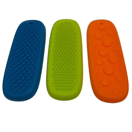 Three colorful Tac Tiles sensory fidgets in blue, green, and orange with varied textured surfaces for tactile play.