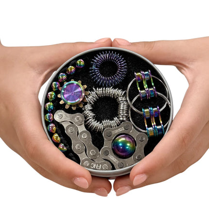 Hands holding The Works Fidget Kit with iridescent and metallic sensory tools inside a round tin container