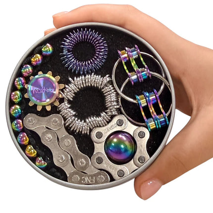 Hand holding The Works Fidget Kit with metallic oil slick sensory and spinner tools in a round tin container