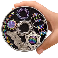 Hand holding The Works Fidget Kit with metallic oil slick sensory and spinner tools in a round tin container