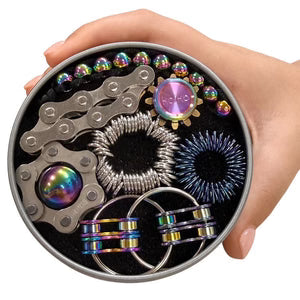 Hand holding a round tin containing The Works Fidget Kit with colorful sensory fidget toys inside