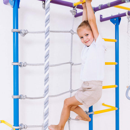 Child using Swedish Giant Wallbars - S7 climbing frame with colorful bars and rope ladder for sensory play.