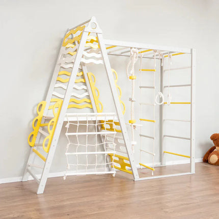 Wooden Teepee Playground climbing frame with yellow accents, rope ladder, and gymnastic rings on wooden floor.