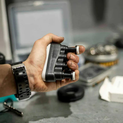 Person gripping a black and white device designed to strengthen fingers and hand muscles, shown in use with Hand & Finger Grip Exerciser & Fidgeting Sensory Tool.