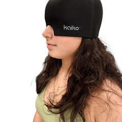 Person wearing the Block Out Cooling Head Mask – a cool ‘hug’ for your head in black covering eyes and head