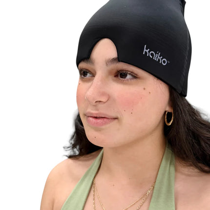 Woman wearing a black Block Out Cooling Head Mask – a cool ‘hug’ for your head, relaxing with closed eyes.