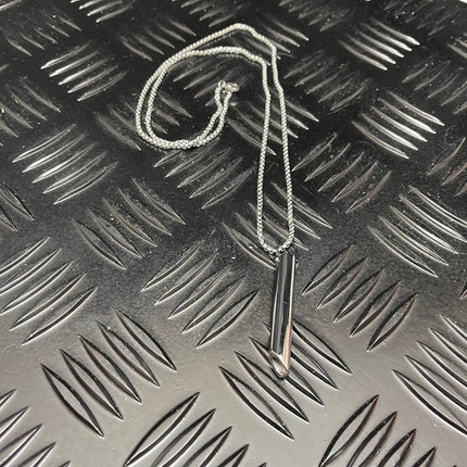Breath Tool 304 grade Stainless Steel IN WINDOW TIN - Mindful Breathing Unisex Necklace on textured metal surface background