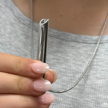 Breath Tool 304 grade Stainless Steel IN WINDOW TIN - Mindful Breathing Unisex Necklace held by person in silver chain