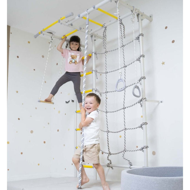 Children playing on indoor climbing frame with rope ladder and swing featuring Swedish Giant Wallbars - S7