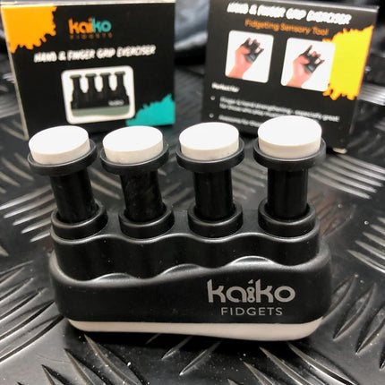 Hand & Finger Grip Exerciser & Fidgeting Sensory Tool in black with white pads for finger resistance training and stress relief, displayed with packaging.