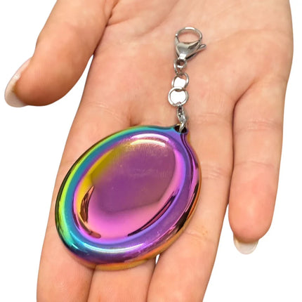 Groove Stone - Dual Support Necklace & Key Chain held in hand, shiny rainbow metallic sensory fidget accessory