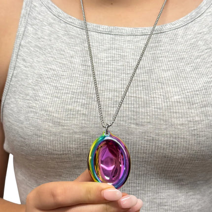 Person holding a colorful metal pendant on chain wearing Groove Stone - Dual Support Necklace & Key Chain