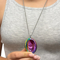 Person holding a colorful metal pendant on chain wearing Groove Stone - Dual Support Necklace & Key Chain