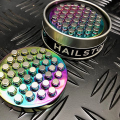 Hailstorm ASMR Fidget - Kaiko Exclusive metal sensory fidget with rainbow colors on textured surface background