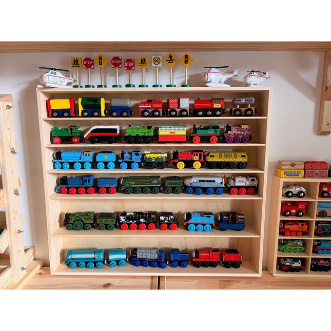 JTRAIN Train Display Rack holding colorful wooden toy trains with road signs and helicopters on top shelves