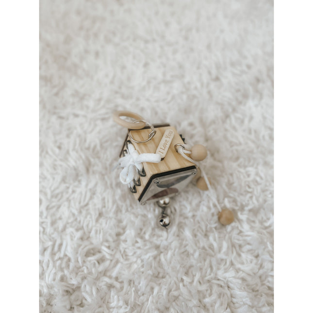 Busy Cube sensory toy with wooden beads, laces, and rings for calming and connecting through play.
