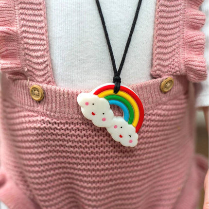 Rainbow Pendant hanging on black cord worn by child in pink knitted outfit, helping families thrive with tools to calm, connect and support