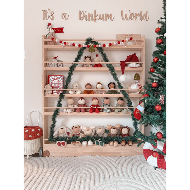 JORY 5 — Front-Facing Bookshelf decorated with garlands and stuffed toys beside a Christmas tree in a cozy room.