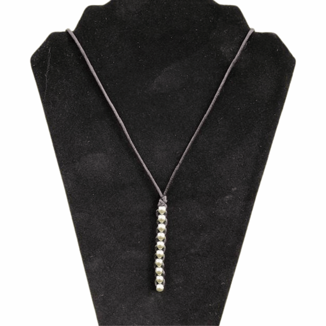 Caterpillar Unisex Necklace with silver bead detail on a simple black cord displayed on a black velvet stand
