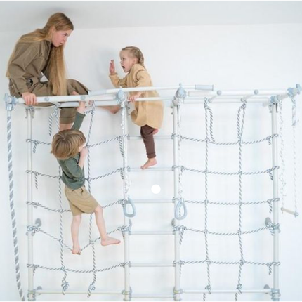 Children playing and climbing on a Sensory Climbing Monkey Bars Ladder with adult supervision indoors