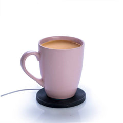 Vinyl Cup Warmer with a pink ceramic mug warming tea, supporting calm and connection at home or office.