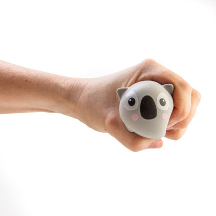 Hand squeezing a soft koala-shaped squishy fidget toy from Smoosho's Pets to help calm and connect.