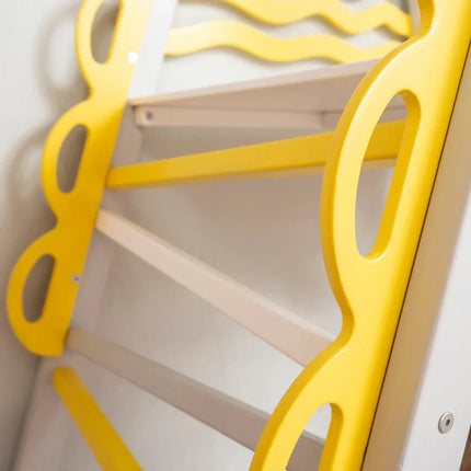 Close-up of the brightly colored yellow and white frame details of the Wooden Teepee Playground.